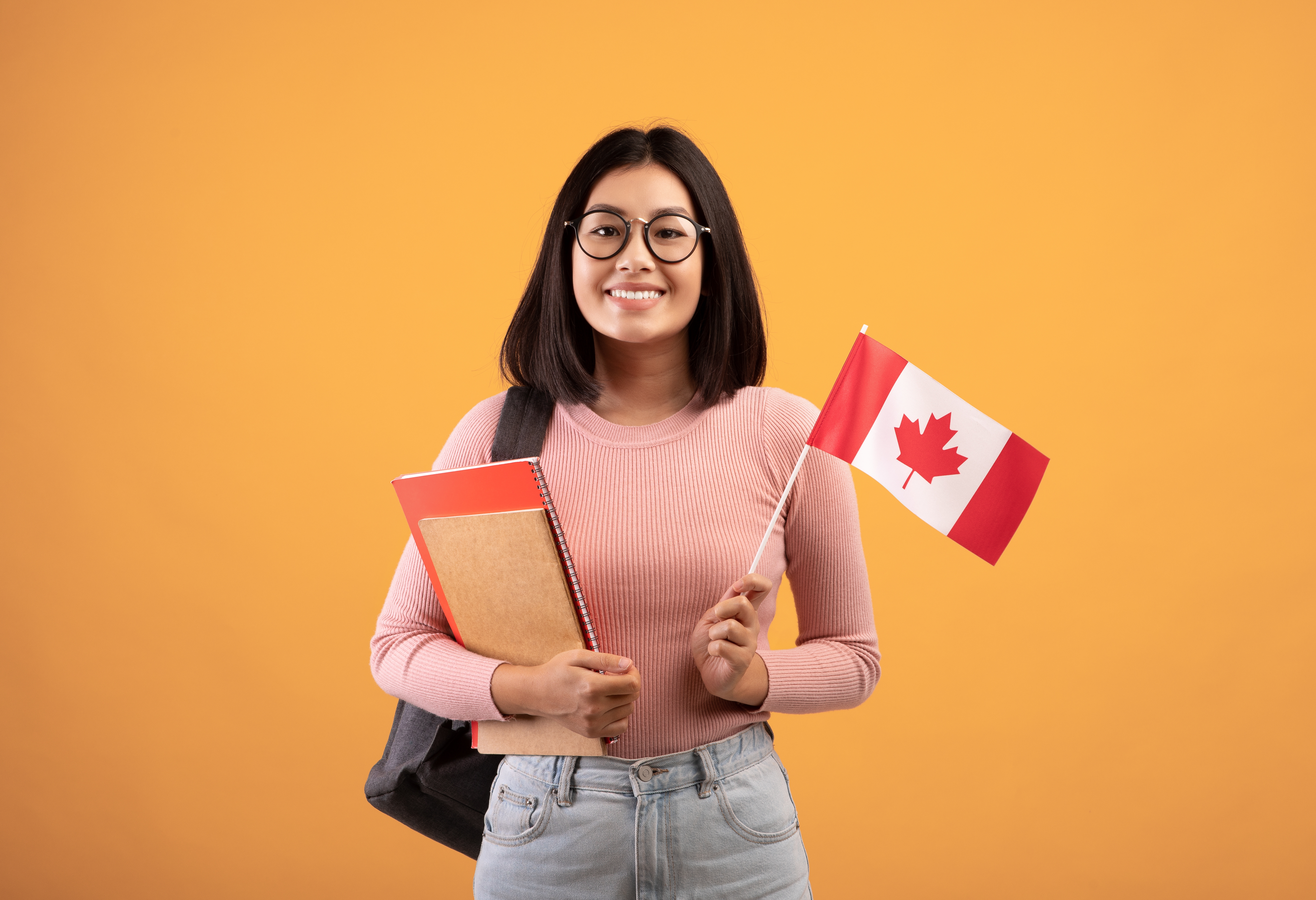 Woman holding Canadian flag | Work in Canada