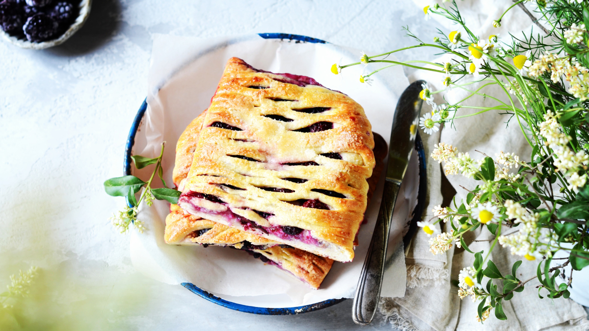 saskatoon berry pie on a plate next to flowers |Why You Should Take a Foodie Holiday in Canada